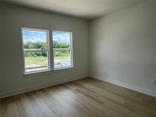 12009 Cearley Dr, Austin, TX 78758 - spare room with wood finished floors and baseboards
