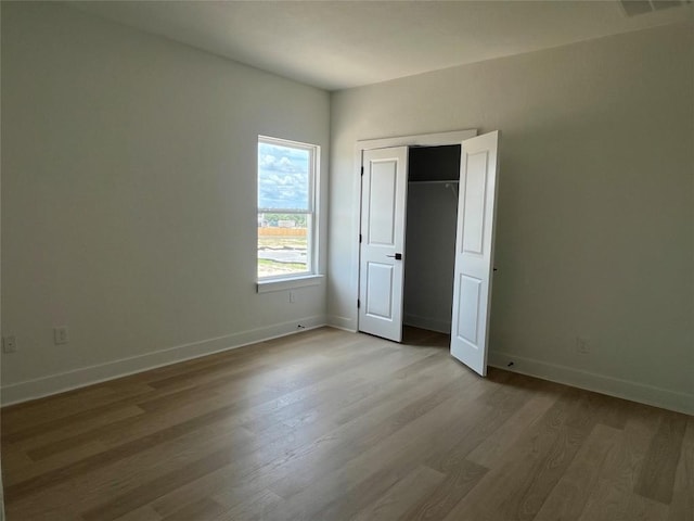 12009 Cearley Dr, Austin, TX 78758 - unfurnished bedroom featuring wood finished floors and a closet