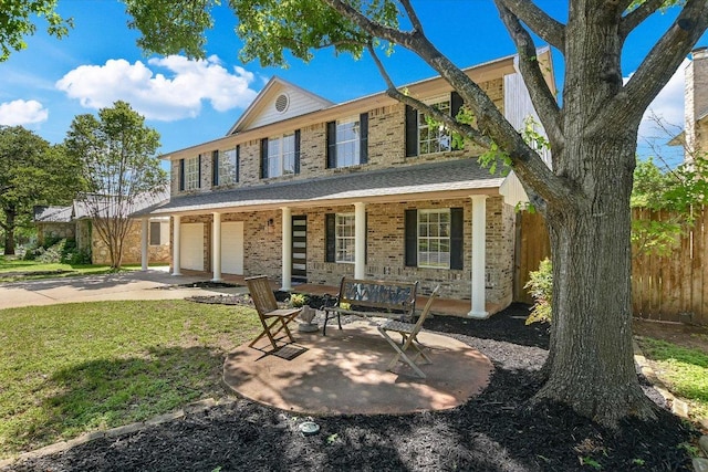 7809 Taranto Dr, Austin, TX 78729 - view of front of home featuring covered porch, a garage, concrete driveway, and brick siding