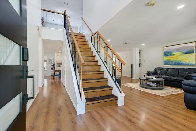7809 Taranto Dr, Austin, TX 78729 - staircase with wood finished floors, recessed lighting, and a high ceiling
