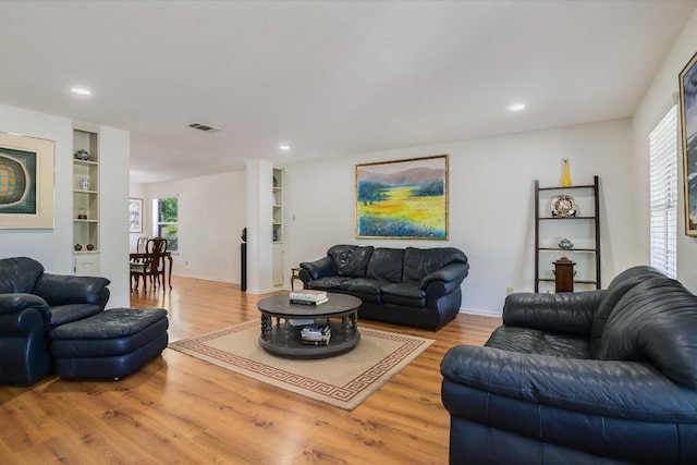 7809 Taranto Dr, Austin, TX 78729 - living room with wood finished floors, built in features, recessed lighting, and baseboards