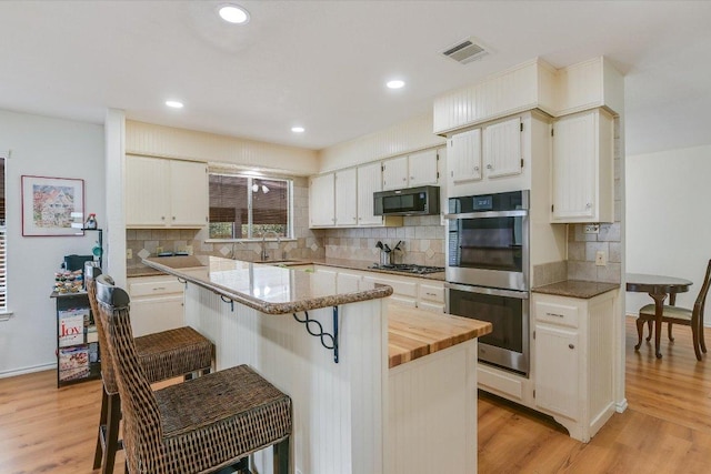 7809 Taranto Dr, Austin, TX 78729 - living area featuring wood finished floors, built in shelves, recessed lighting, and baseboards