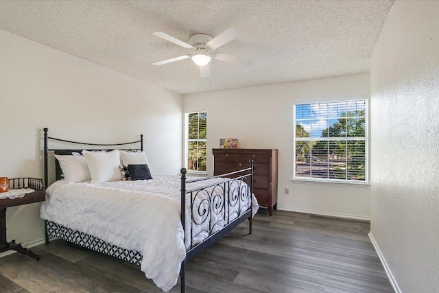 7809 Taranto Dr, Austin, TX 78729 - bedroom with a textured ceiling, wood finished floors, baseboards, and a ceiling fan