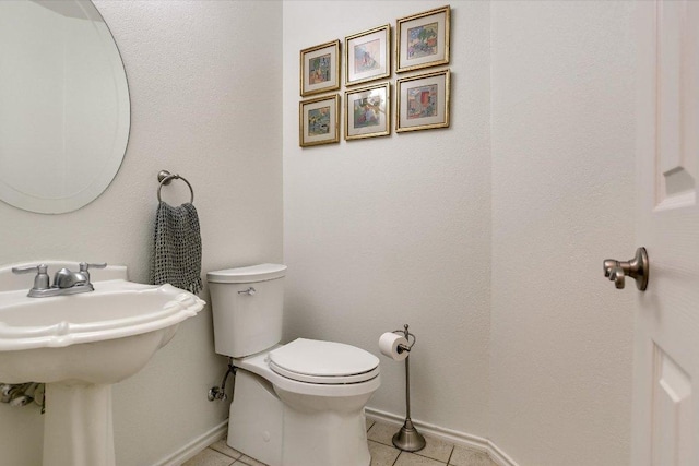 7809 Taranto Dr, Austin, TX 78729 - half bath with baseboards, tile patterned flooring, toilet, and a sink