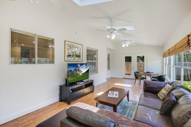 7809 Taranto Dr, Austin, TX 78729 - living room featuring a ceiling fan, a skylight, vaulted ceiling, wood finished floors, and french doors