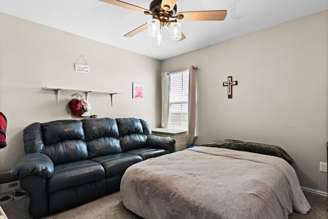 carpeted bedroom with baseboards and ceiling fan
