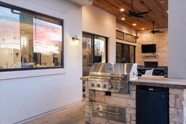 821 S Angel Light Dr, Spicewood, TX 78669 - view of patio featuring an outdoor kitchen, a stone fireplace, and ceiling fan
