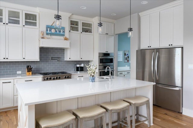 821 S Angel Light Dr, Spicewood, TX 78669 - kitchen featuring appliances with stainless steel finishes, decorative backsplash, light countertops, and white cabinetry