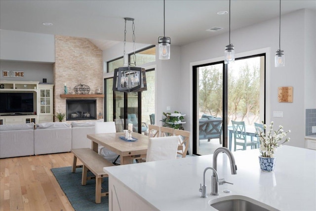 821 S Angel Light Dr, Spicewood, TX 78669 - kitchen with light wood-style floors, decorative light fixtures, light countertops, and vaulted ceiling