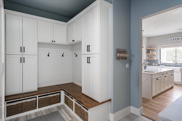 821 S Angel Light Dr, Spicewood, TX 78669 - mudroom featuring baseboards, light wood finished floors, a sink, and recessed lighting