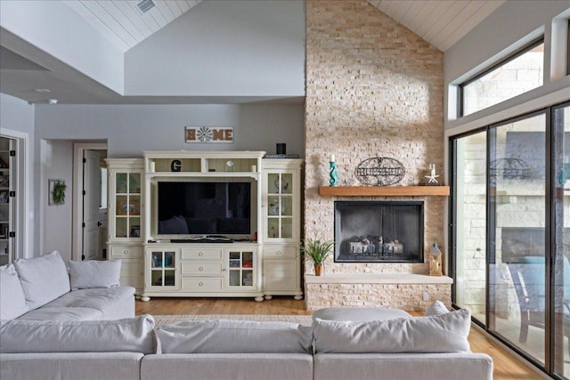 821 S Angel Light Dr, Spicewood, TX 78669 - living area featuring wood finished floors, high vaulted ceiling, wooden ceiling, and a large fireplace