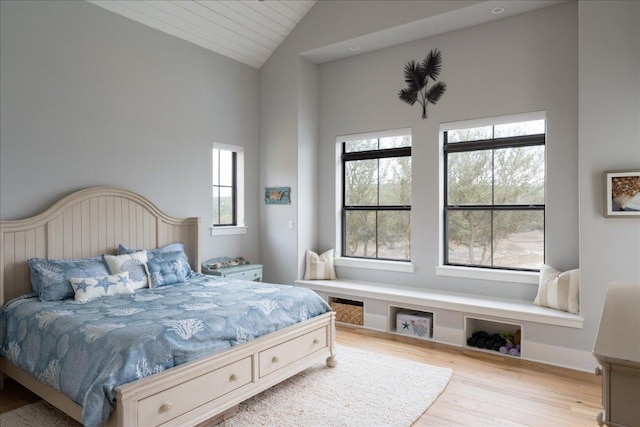 821 S Angel Light Dr, Spicewood, TX 78669 - bedroom with multiple windows, vaulted ceiling, and wood finished floors
