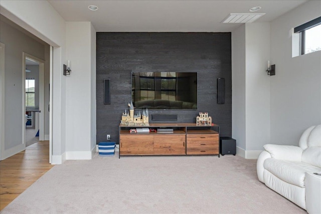 821 S Angel Light Dr, Spicewood, TX 78669 - carpeted living room featuring an accent wall, baseboards, and recessed lighting