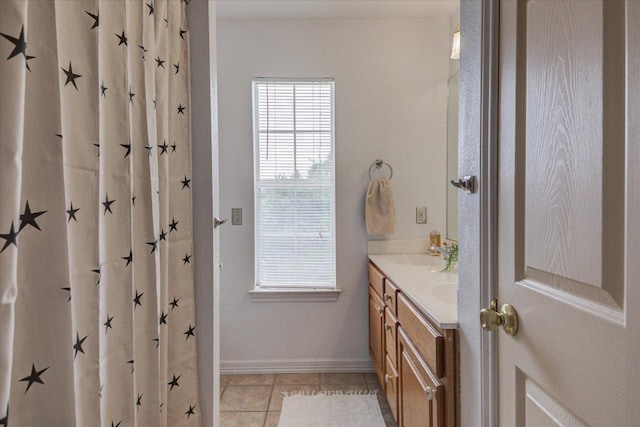 22230 Stow Cir, Spicewood, TX 78669 - bathroom featuring double vanity, tile patterned flooring, and baseboards