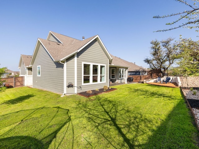 1491 Hazy Hills Loop, Dripping Springs, TX 78620 - back of house with roof with shingles, a yard, and a fenced backyard