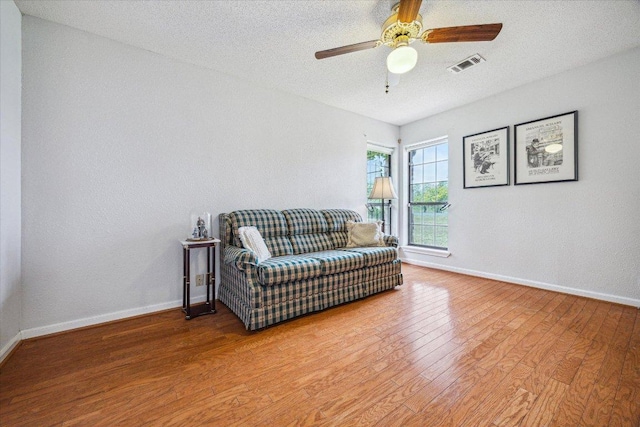 59 Fairview Dr, Round Rock, TX 78665 - living area with wood finished floors, a ceiling fan, and a textured ceiling