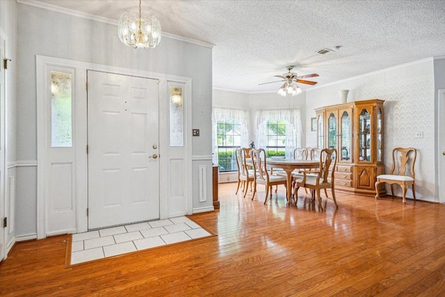 59 Fairview Dr, Round Rock, TX 78665 - foyer with hardwood / wood-style floors, crown molding, a chandelier, ceiling fan, and a textured ceiling