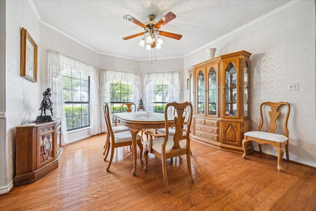 59 Fairview Dr, Round Rock, TX 78665 - dining area featuring a textured ceiling, light wood-style flooring, a ceiling fan, and crown molding