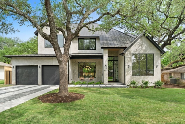 view of front of home with aphalt driveway, stucco siding, a front yard, and a garage