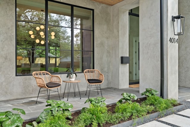 view of exterior entry with a patio