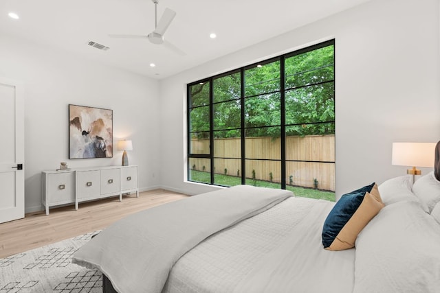 bedroom with baseboards, recessed lighting, a ceiling fan, visible vents, and wood finished floors