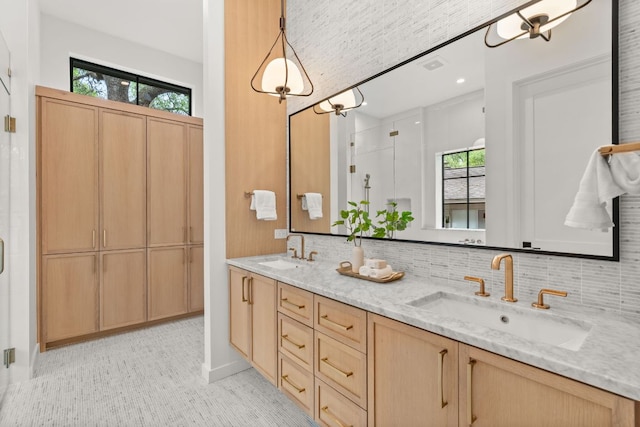 full bath with a sink, a wealth of natural light, and a stall shower