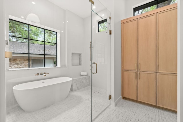 bathroom with a shower stall, a freestanding bath, tile patterned flooring, and recessed lighting