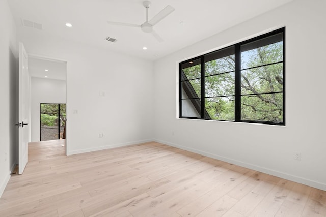 unfurnished room featuring visible vents, baseboards, and light wood-type flooring