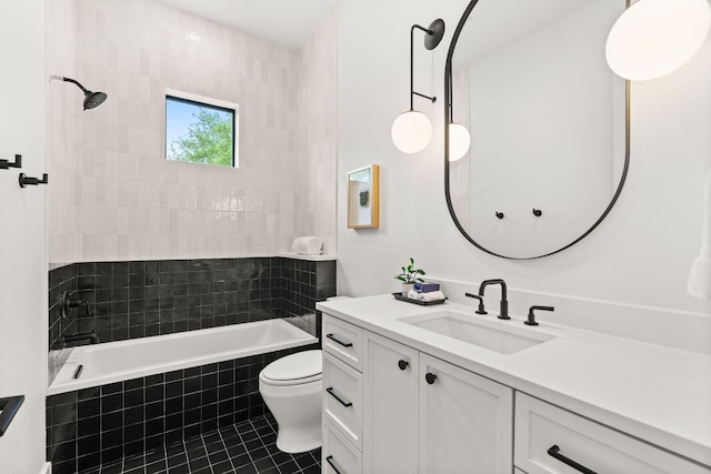 full bathroom featuring tile patterned flooring, vanity, tiled shower / bath combo, and toilet