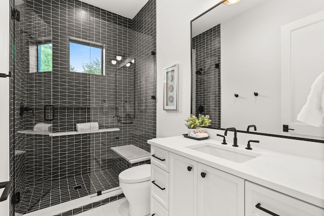 full bath featuring a shower stall, tile patterned flooring, vanity, and toilet