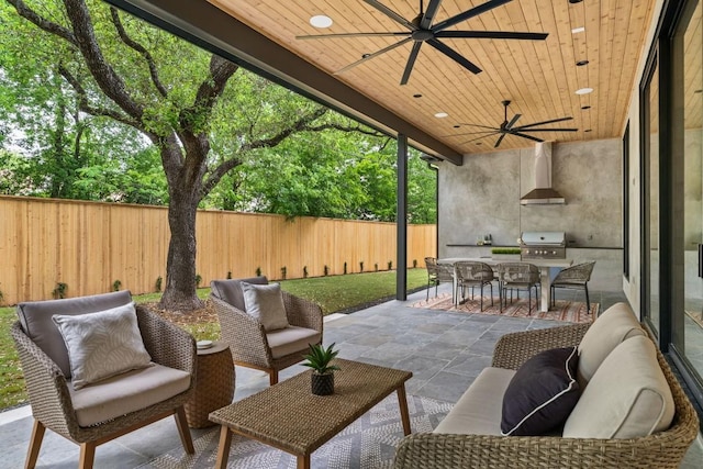 view of patio / terrace with exterior kitchen, area for grilling, a fenced backyard, outdoor dining area, and an outdoor hangout area