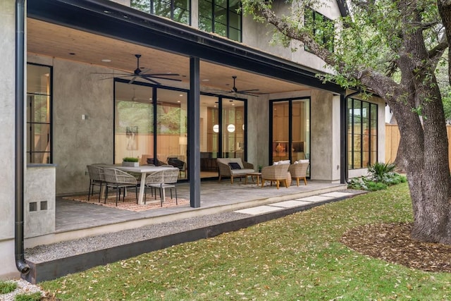 back of property with a patio area, an outdoor living space, visible vents, and a ceiling fan
