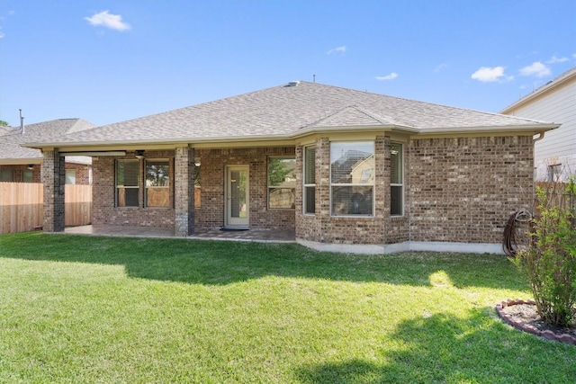 2529 Mirasol Loop, Round Rock, TX 78681 - rear view of house with brick siding, a patio area, and a shingled roof