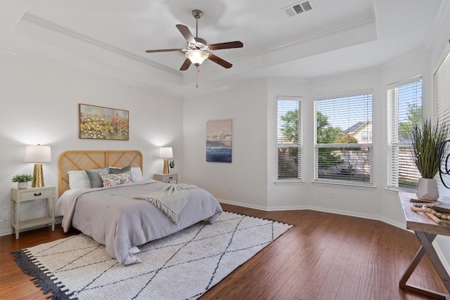 2529 Mirasol Loop, Round Rock, TX 78681 - bedroom with a tray ceiling, multiple windows, hardwood / wood-style floors, crown molding, and a ceiling fan