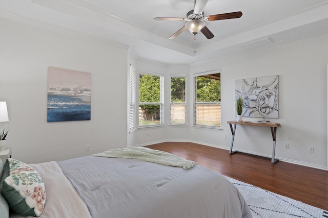 2529 Mirasol Loop, Round Rock, TX 78681 - bedroom featuring wood finished floors, a tray ceiling, crown molding, and ceiling fan