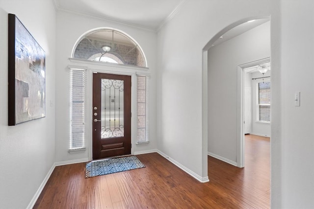 2529 Mirasol Loop, Round Rock, TX 78681 - entrance foyer with wood finished floors, arched walkways, baseboards, and crown molding