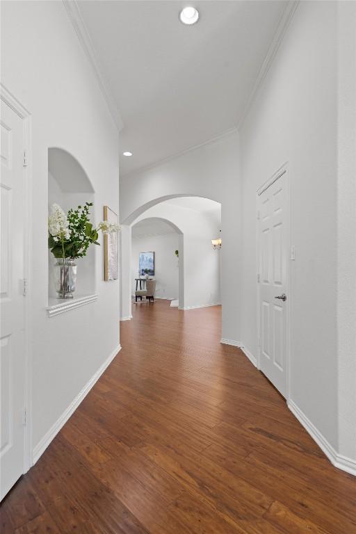2529 Mirasol Loop, Round Rock, TX 78681 - hall with ornamental molding, arched walkways, wood finished floors, recessed lighting, and baseboards