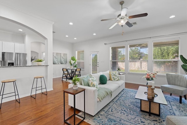 2529 Mirasol Loop, Round Rock, TX 78681 - living area featuring crown molding, wood finished floors, recessed lighting, arched walkways, and ceiling fan