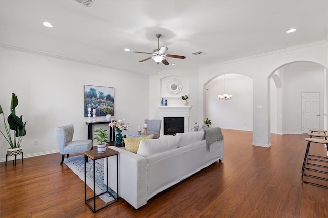 2529 Mirasol Loop, Round Rock, TX 78681 - living area featuring arched walkways, a ceiling fan, recessed lighting, dark wood-type flooring, and a glass covered fireplace