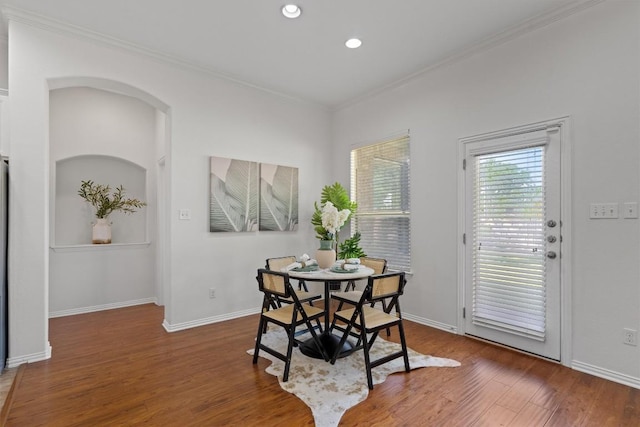 2529 Mirasol Loop, Round Rock, TX 78681 - dining area featuring ornamental molding, wood finished floors, arched walkways, recessed lighting, and baseboards