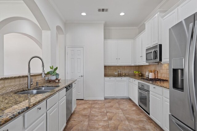 2529 Mirasol Loop, Round Rock, TX 78681 - kitchen with stainless steel appliances, white cabinetry, stone counters, recessed lighting, and ornamental molding