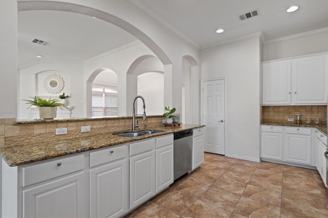 2529 Mirasol Loop, Round Rock, TX 78681 - kitchen featuring stainless steel dishwasher, a sink, backsplash, white cabinets, and dark stone counters