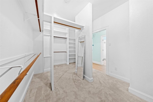 walk in closet featuring carpet