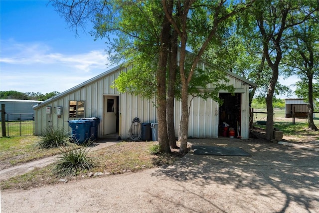 view of outbuilding featuring an outbuilding and fence