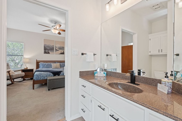 bathroom featuring a ceiling fan, vanity, and toilet