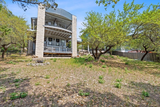 21726 Sierra Trl, Lago Vista, TX 78645 - back of house with a balcony, a fire pit, a chimney, and a ceiling fan