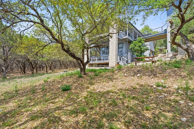 21726 Sierra Trl, Lago Vista, TX 78645 - view of front facade featuring a balcony, a porch, and stairway