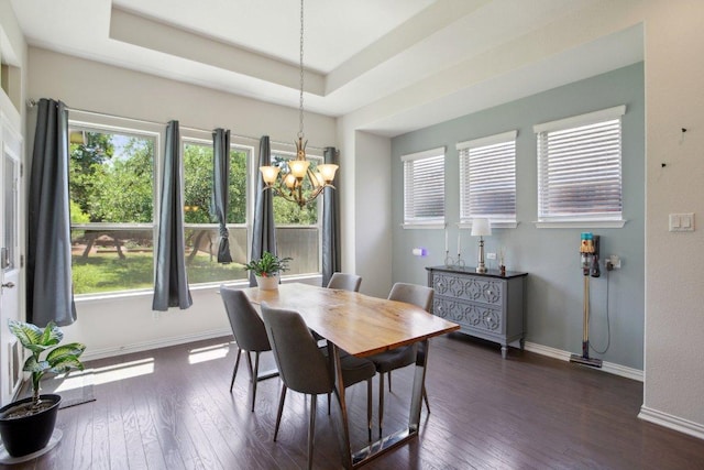 dining room featuring dark wood-style flooring, baseboards, a notable chandelier, and a healthy amount of sunlight