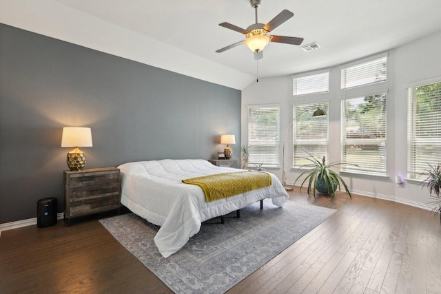 bedroom with dark wood finished floors, baseboards, visible vents, lofted ceiling, and ceiling fan
