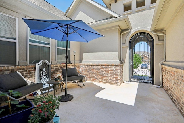 property entrance featuring brick siding and stucco siding